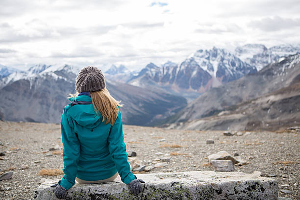 Hiker at mountain top enjoying landscape