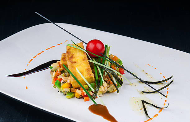 istock Decorated vegetable salad served on a white plate 493741122