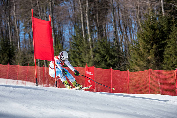 istock Professional Alpine Skier in Low Pose Zooming past pole gate 493741276