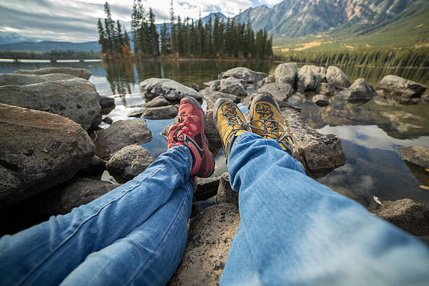 istock Two people relaxing on rocks by the lake 493741304