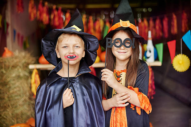 Witch and wizard in scary masks on Witch and wizard in scary masks on wizard photos stock pictures, royalty-free photos & images