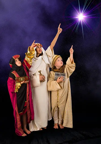 Wisemen played by three girls in a live Christmas nativity scene