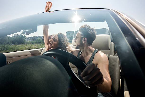 istock Excited couple having fun on a road trip in cabriolet. 493745496