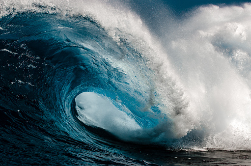 Nature's power on display as this huge blue wave thunders across the reef.