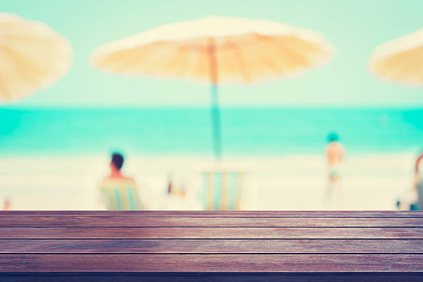 istock Old wood table top on blurred beach background 493746692