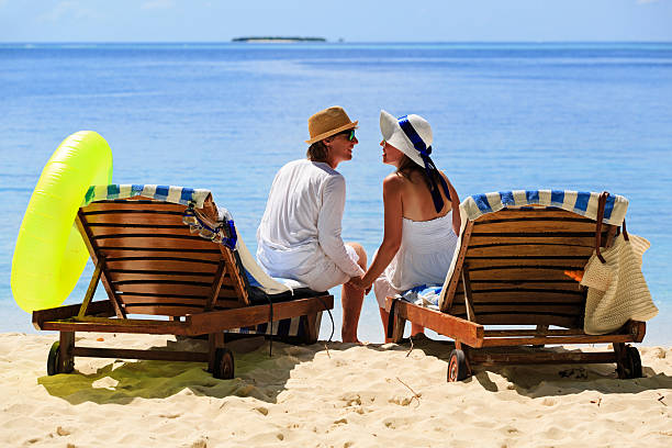 istock loving couple on tropical beach 493748112