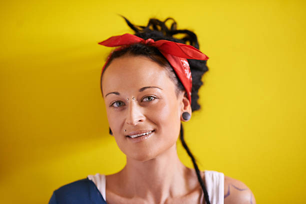 Portrait of a young woman with dreadlocks standing against a yellow backgroundhttp://195.154.178.81/DATA/i_collage/pu/shoots/805796.jpg