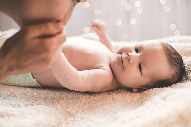 istock Woman kissing her child hand 493749080