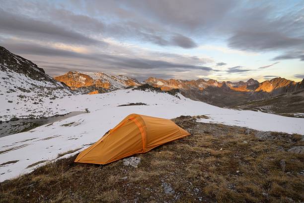 istock One orange tent in the mountains. 493759246