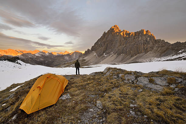 istock Man with tent observes the Alps at dawn. 493759622