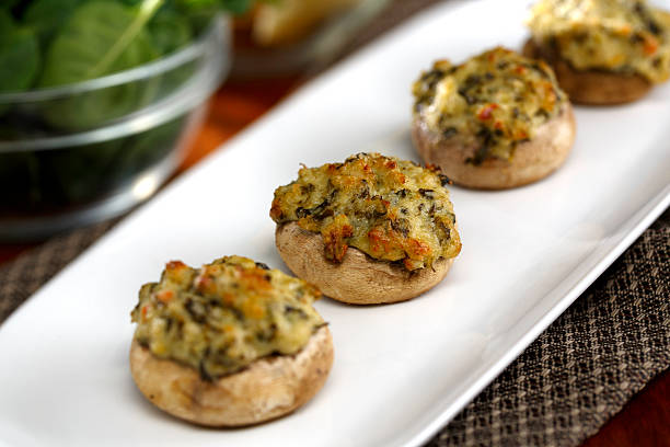 Crab Stuffed Mushrooms Crab Stuffed Mushrooms with Spinach & Artichoke Horizontal format stuffed photos stock pictures, royalty-free photos & images