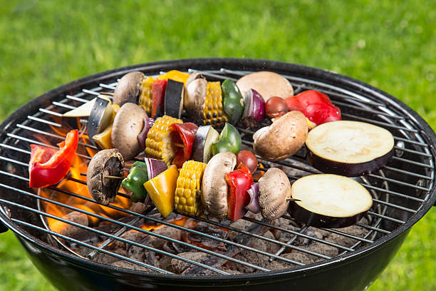 Delicious grilled vegetarian skewers on burning coals