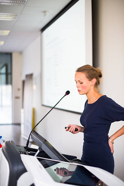istock Pretty, young business woman giving a presentation 493763435