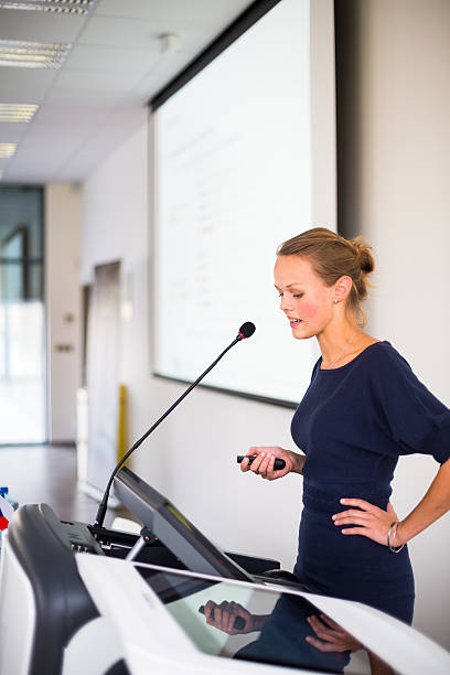 istock Pretty, young business woman giving a presentation 493763439