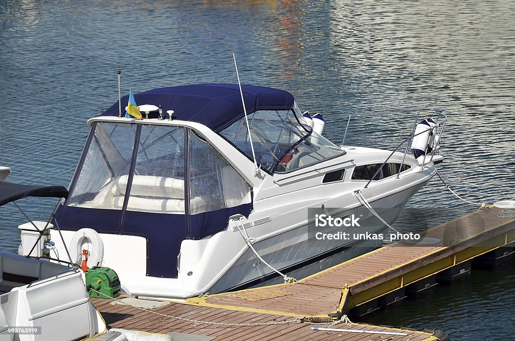 Motor yacht White motor yacht over harbor pier, Odessa, Ukraine Bay of Water Stock Photo