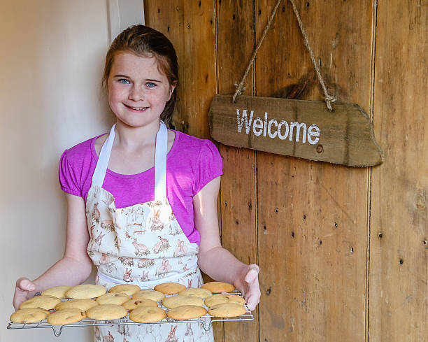 Young girl offering a welcome  tray of cookies or biscuits