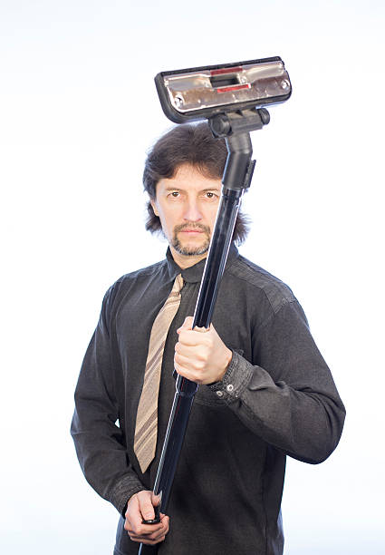 istock man in black shirt is holding a vacuum cleaner 493764590