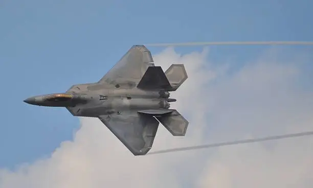 Top-view of an Air Force F-22 Raptor banking in flight.