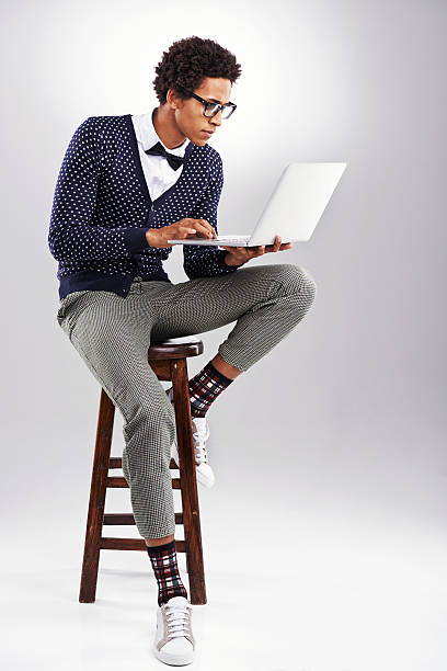 Just getting into this blogging thing Studio shot of a young man using a laptop against a gray backgroundhttp://195.154.178.81/DATA/i_collage/pu/shoots/805791.jpg preppy fashion stock pictures, royalty-free photos & images