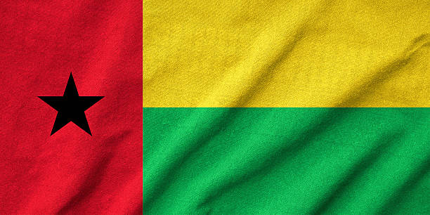 gerüschter guinea-bissau flagge - guinea bissau flag stock-fotos und bilder