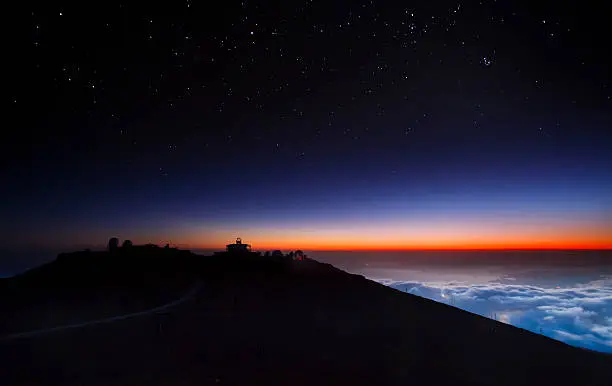 Evening sky at the summit of Maui's majestic Haleakala Volcano. Known for its spectacular sunrises and sunsets, Haleakala is also a premier location for stargazing and astronomical research, at an elevation of 10,023 feet (3,055 meters) above the Pacific Ocean.