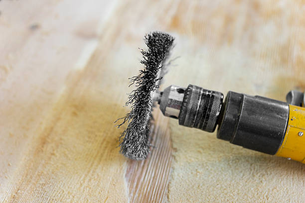 istock Electrical rotating brush metal disk sanding piece of wood 493766380