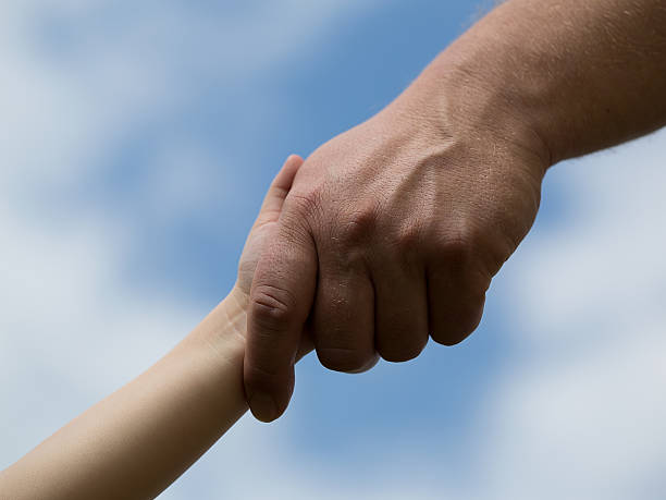 istock Father and Child Holding Hands 493767617