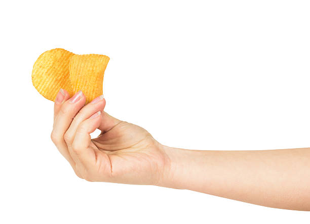 istock Hand holds a couple of potato chips 493768008