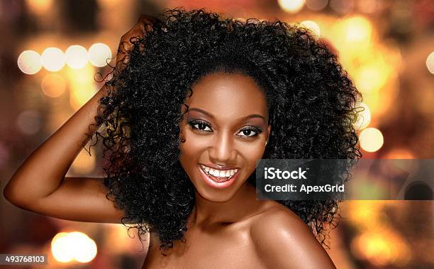 Young Woman Happy With Curly Hair On A Bright Background Stock Photo - Download Image Now