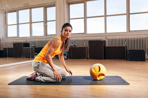 istock Muscular young woman exercising at gym with kettlebell 493768628