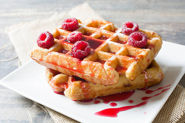 istock Waffles with raspberries and strawberry syrup 493769072