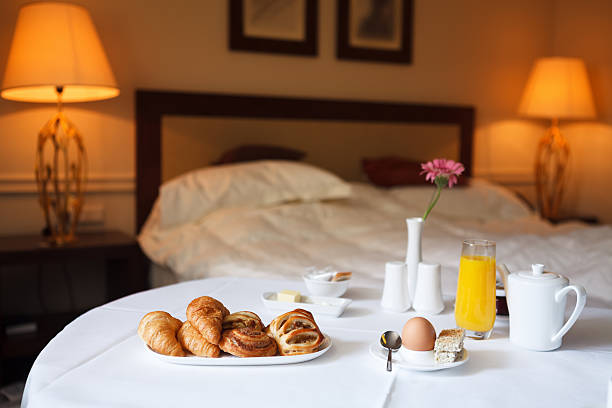 Breakfast In Bed Breakfast ordered in a hotel room. bed breakfast pictures stock pictures, royalty-free photos & images