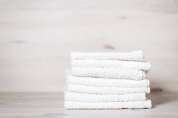 istock stack of spa towels on white wooden table 493769820