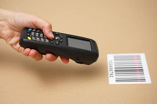 Scanning label on the box with barcode scanner stock photo