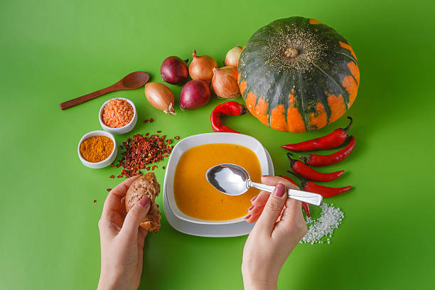 Pumpkin soup with onion and pepper on green shadowless backgroud