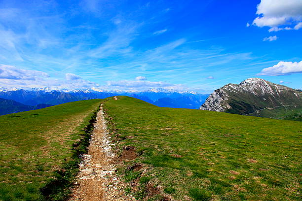 Freedom paradise: Alpine trail, hiking to horizon, blue Sky, clouds, Dolomites.