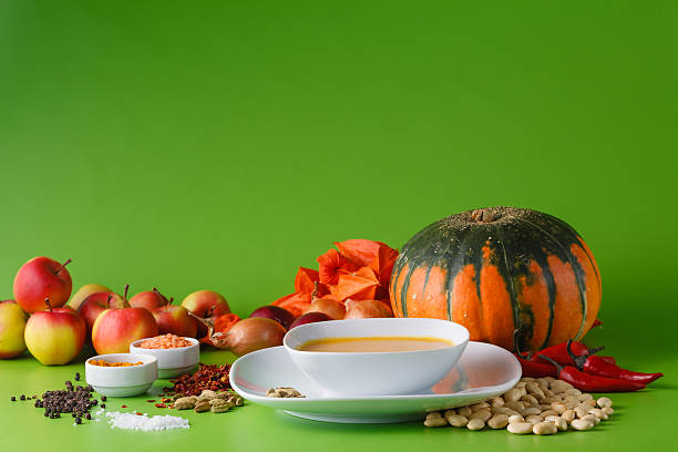Pumpkin soup with onion and pepper on green shadowless backgroud