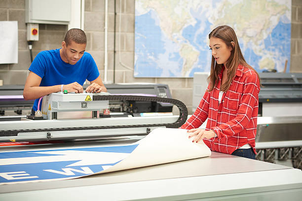 istock young woman working at a digital printers 493784266