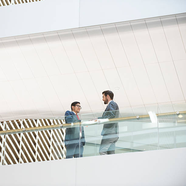 istock Two businessmen meeting high up in modern office building 493785062
