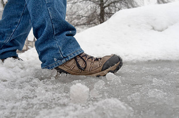 close up of man walking in slushy wet snow at surface level. Winter weather.