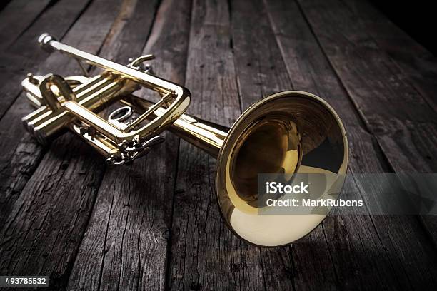 Trumpet On An Old Wooden Table Stock Photo - Download Image Now - Trumpet, Table, Cornet