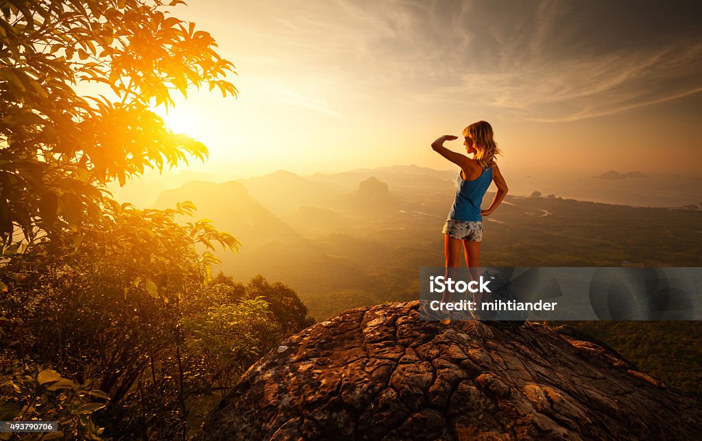 Tourist Lady hiker on top of the mountain during sunrise Travel Stock Photo