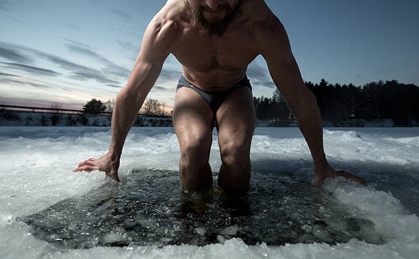 Ice hole Young man having recreational swim in the ice hole just do it stock pictures, royalty-free photos & images