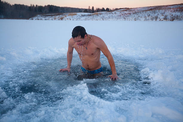 Ice hole Young man having recreational swim in the ice hole just do it stock pictures, royalty-free photos & images