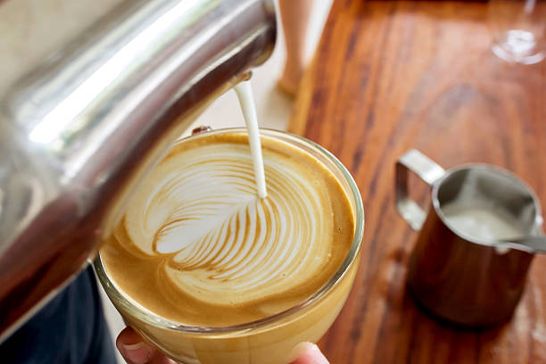 istock Barista making latte art in coffee cup 493794768