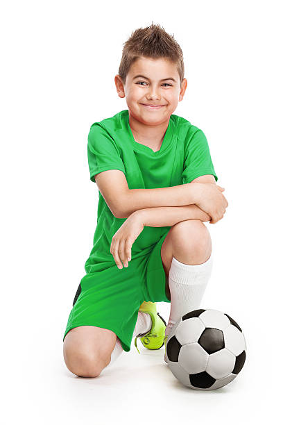 istock kneeling young soccer player with football 493795068