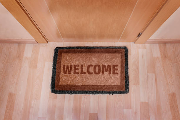istock Welcome home doormat with closed door 493801309