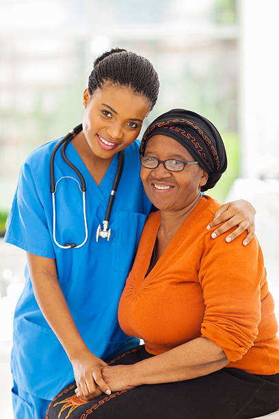 istock caring african nurse and senior patient 493802271