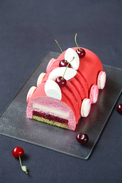 Cherry Lychee and Pistachio Yule Log Cake stock photo