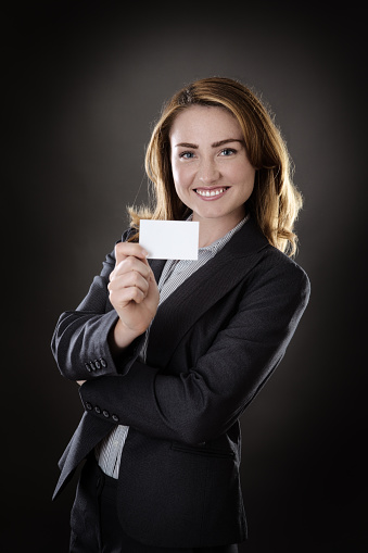 business woman holding up and showing you a blank white card